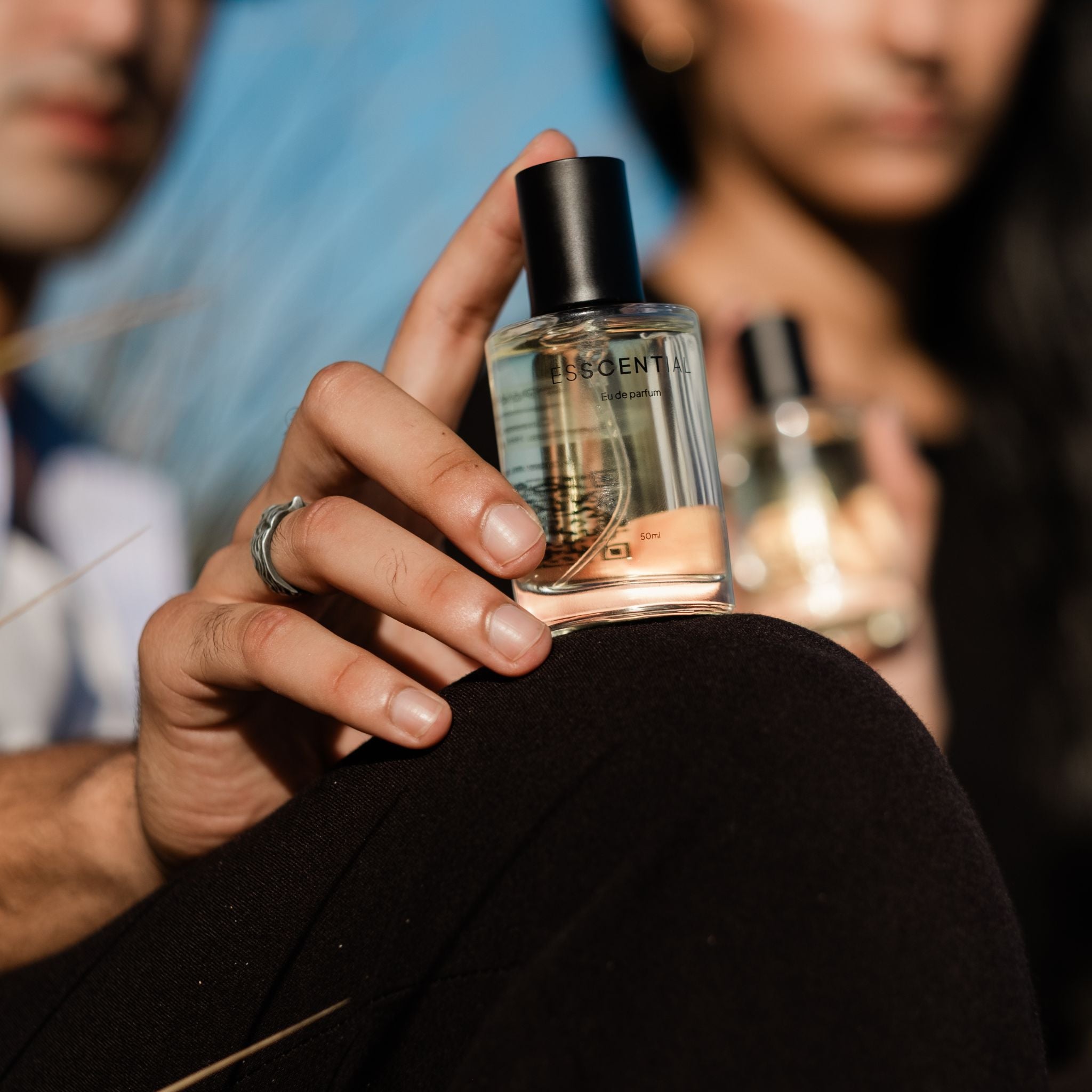 Close up of guy and girl holding perfume South Africa